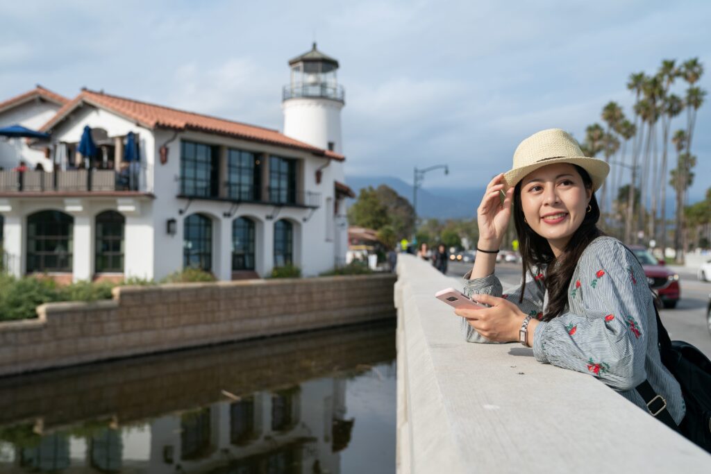 female-leaning-on-railing-near-lighthouse